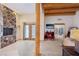 Spacious bedroom showcases rock wall and doorway leading to an outside patio at 519 N Racetrack Rd, Henderson, NV 89015