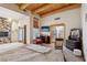 Spacious bedroom with wooden beams has seating and double doors to the outside at 519 N Racetrack Rd, Henderson, NV 89015