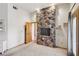 Open bedroom features a rock wall accent and doorway leading to another room at 519 N Racetrack Rd, Henderson, NV 89015