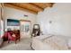 Bedroom with wooden beams featuring seating area and doorway leading to another room at 519 N Racetrack Rd, Henderson, NV 89015