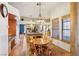 Bright breakfast nook featuring terracotta tile flooring, wooden accents, and a view of the kitchen at 519 N Racetrack Rd, Henderson, NV 89015