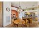 Charming breakfast nook featuring terracotta tile flooring, wooden accents, and a view of the kitchen at 519 N Racetrack Rd, Henderson, NV 89015