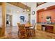 Cozy breakfast nook featuring terracotta tile flooring, wooden accents, and a view of the living room at 519 N Racetrack Rd, Henderson, NV 89015