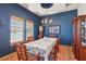 Beautiful dining room with a decorative ceiling, wooden furniture, and natural light from the windows at 519 N Racetrack Rd, Henderson, NV 89015