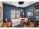 Elegant dining room with a decorative ceiling, wooden furniture, and a stylish chandelier at 519 N Racetrack Rd, Henderson, NV 89015