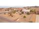 Expansive desert home with neutral tones and landscaped yard with native plants, situated in desert community near mountains at 519 N Racetrack Rd, Henderson, NV 89015