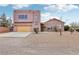 Southwestern-style home with an attached garage and desert landscaping at 519 N Racetrack Rd, Henderson, NV 89015