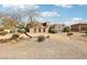 Desert home featuring beautiful desert landscaping and a unique stucco exterior with a tile roof at 519 N Racetrack Rd, Henderson, NV 89015