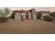 Charming stucco home with a beautiful wooden door and desert landscaping at 519 N Racetrack Rd, Henderson, NV 89015