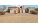 Charming stucco home with a beautiful wooden door and desert landscaping at 519 N Racetrack Rd, Henderson, NV 89015