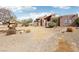 Charming Southwestern-style home with a stucco exterior, desert landscaping, and tile roofing at 519 N Racetrack Rd, Henderson, NV 89015