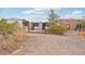 Charming single-story home with drought resistant landscaping and fenced front yard, exterior buildings to the left at 519 N Racetrack Rd, Henderson, NV 89015