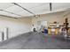 Clean and spacious garage with ample storage space and a work area at 519 N Racetrack Rd, Henderson, NV 89015