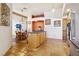 Open kitchen view showcasing stainless steel appliances, wood cabinets, and a dining area with natural light at 519 N Racetrack Rd, Henderson, NV 89015