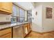 Bright kitchen featuring stainless steel appliances, wooden cabinets, granite countertops, and a window with natural light at 519 N Racetrack Rd, Henderson, NV 89015