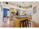 Spacious kitchen featuring stainless steel appliances, an island with seating, and warm-toned tile flooring at 519 N Racetrack Rd, Henderson, NV 89015
