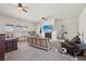 Spacious living room with a fireplace, neutral-toned furniture, and bright natural light from large windows at 519 N Racetrack Rd, Henderson, NV 89015