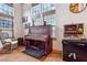 Cozy seating area featuring a vintage piano, window with view, and a classic game machine at 519 N Racetrack Rd, Henderson, NV 89015