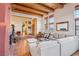 Inviting living room with a fireplace, exposed wood beam ceiling, and a view of the foyer and hallway at 519 N Racetrack Rd, Henderson, NV 89015
