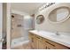 Bright bathroom featuring a double vanity with framed mirrors and a walk-in shower at 5438 Cholla Cactus Ave, Las Vegas, NV 89141