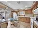 Eat-in kitchen featuring wood cabinetry, tile floors, and sliding glass doors at 5438 Cholla Cactus Ave, Las Vegas, NV 89141