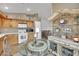 Eat-in kitchen featuring wood cabinetry, tile floors, and sliding glass doors at 5438 Cholla Cactus Ave, Las Vegas, NV 89141