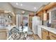 Eat-in kitchen with wood cabinets, white appliances, and sliding glass door to the outside patio at 5438 Cholla Cactus Ave, Las Vegas, NV 89141