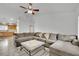 Bright living room featuring a plush sofa, ceiling fan, and tile floors at 5438 Cholla Cactus Ave, Las Vegas, NV 89141