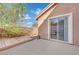 Cozy backyard patio with a wooden deck, sliding glass door, and desert landscaping at 5438 Cholla Cactus Ave, Las Vegas, NV 89141