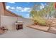 Back patio with grill, wooden platform, and a light colored privacy fence at 5438 Cholla Cactus Ave, Las Vegas, NV 89141