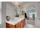 Bathroom featuring double sinks with wooden cabinets and neutral wall color at 5537 Parlay Way # 101, Las Vegas, NV 89122