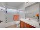 Bright bathroom features a tub with shower, wooden cabinets and neutral wall color at 5537 Parlay Way # 101, Las Vegas, NV 89122