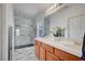 Luxurious bathroom featuring a marble-tiled shower, double sink, and a spacious vanity at 5537 Parlay Way # 101, Las Vegas, NV 89122