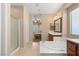 Bathroom featuring a soaking tub, double vanity, and walk-in shower at 5809 Sagamore Canyon St, North Las Vegas, NV 89081