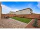 Paver patio and artificial turf create a low maintenance backyard perfect for outdoor living at 6346 Rock Strm Ln, Las Vegas, NV 89141