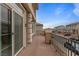 Second story private balcony with metal railing and brick accents, offering neighborhood views at 6346 Rock Strm Ln, Las Vegas, NV 89141
