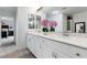 Well-lit bathroom with double vanity, white cabinets, and quartz countertop at 6346 Rock Strm Ln, Las Vegas, NV 89141