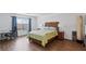Bright bedroom featuring a queen-size bed, a desk, and hardwood floors at 6346 Rock Strm Ln, Las Vegas, NV 89141
