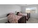 Well-lit bedroom showcasing two twin beds with patterned bedding and a view from the window at 6346 Rock Strm Ln, Las Vegas, NV 89141