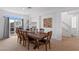 Dining room boasts a wooden table and chairs with sliding glass doors and neutral carpet at 6346 Rock Strm Ln, Las Vegas, NV 89141