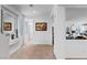 Bright hallway featuring neutral walls, carpet, and a decorative mirror at 6346 Rock Strm Ln, Las Vegas, NV 89141