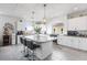 Bright kitchen featuring stainless appliances, white cabinetry, granite counters, a large island, and contemporary pendant lighting at 6346 Rock Strm Ln, Las Vegas, NV 89141