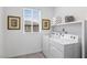 Bright laundry room with front-loading washer and dryer, plus storage shelf at 6346 Rock Strm Ln, Las Vegas, NV 89141