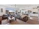 Spacious living room with a large sofa, big windows, and open access to the kitchen at 6346 Rock Strm Ln, Las Vegas, NV 89141