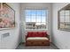 Cozy nook with bench seat, red pillows, window view, and artwork on wall at 6346 Rock Strm Ln, Las Vegas, NV 89141
