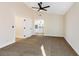 Bedroom with carpet, ceiling fan, and easy access to the bathroom at 6628 Silver Penny Ave, Las Vegas, NV 89108