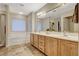 This bathroom is bright and features a double vanity, separate tub and shower, and tile floors at 6828 Sumatra St, Las Vegas, NV 89166