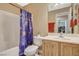 Cozy bathroom featuring a shower-tub combination, vanity, and unique celestial-themed shower curtain at 6828 Sumatra St, Las Vegas, NV 89166