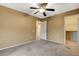 Bedroom featuring a ceiling fan, neutral carpet, and a walk-in closet at 6828 Sumatra St, Las Vegas, NV 89166