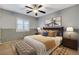 Cozy bedroom with two-toned walls, ceiling fan, neutral carpet, and a plush bed at 6828 Sumatra St, Las Vegas, NV 89166